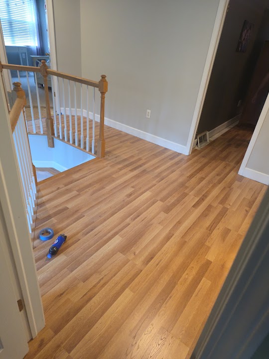 Wood-look flooring next to an indoor railing
