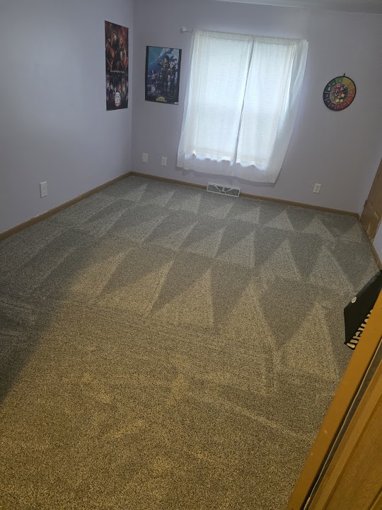 Carpeted room with vacuum marks and a window at the back